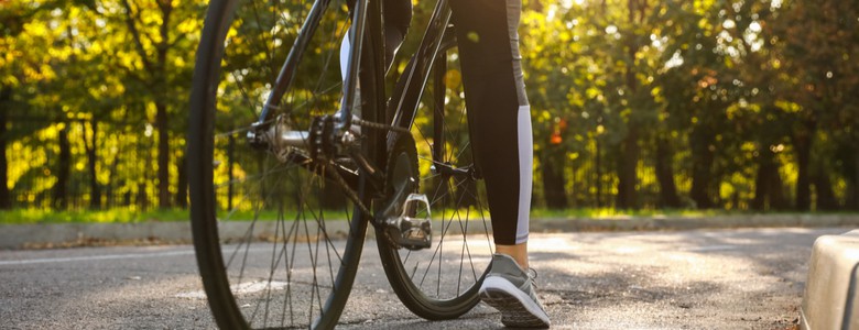 A female cyclist at the side of the road, preparing to ride off