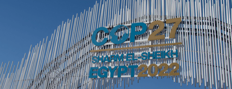 The logo for Cop27 on the conference’s main gate against a blue sky