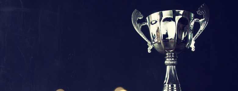 A silver trophy against a black backdrop
