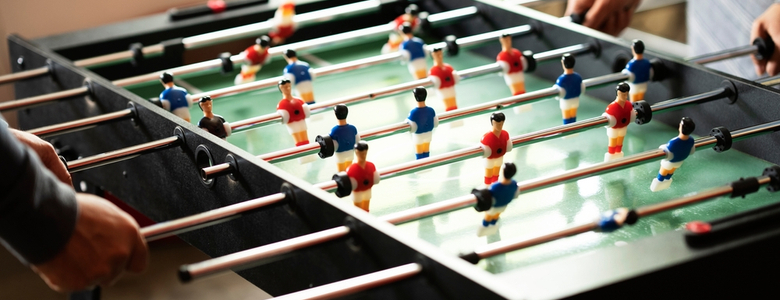 Close-up of two people playing table football