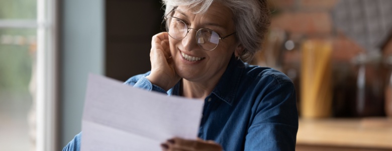 An older woman looking at a piece of paper