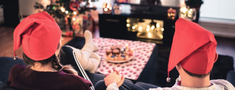 A couple watching TV at Christmas